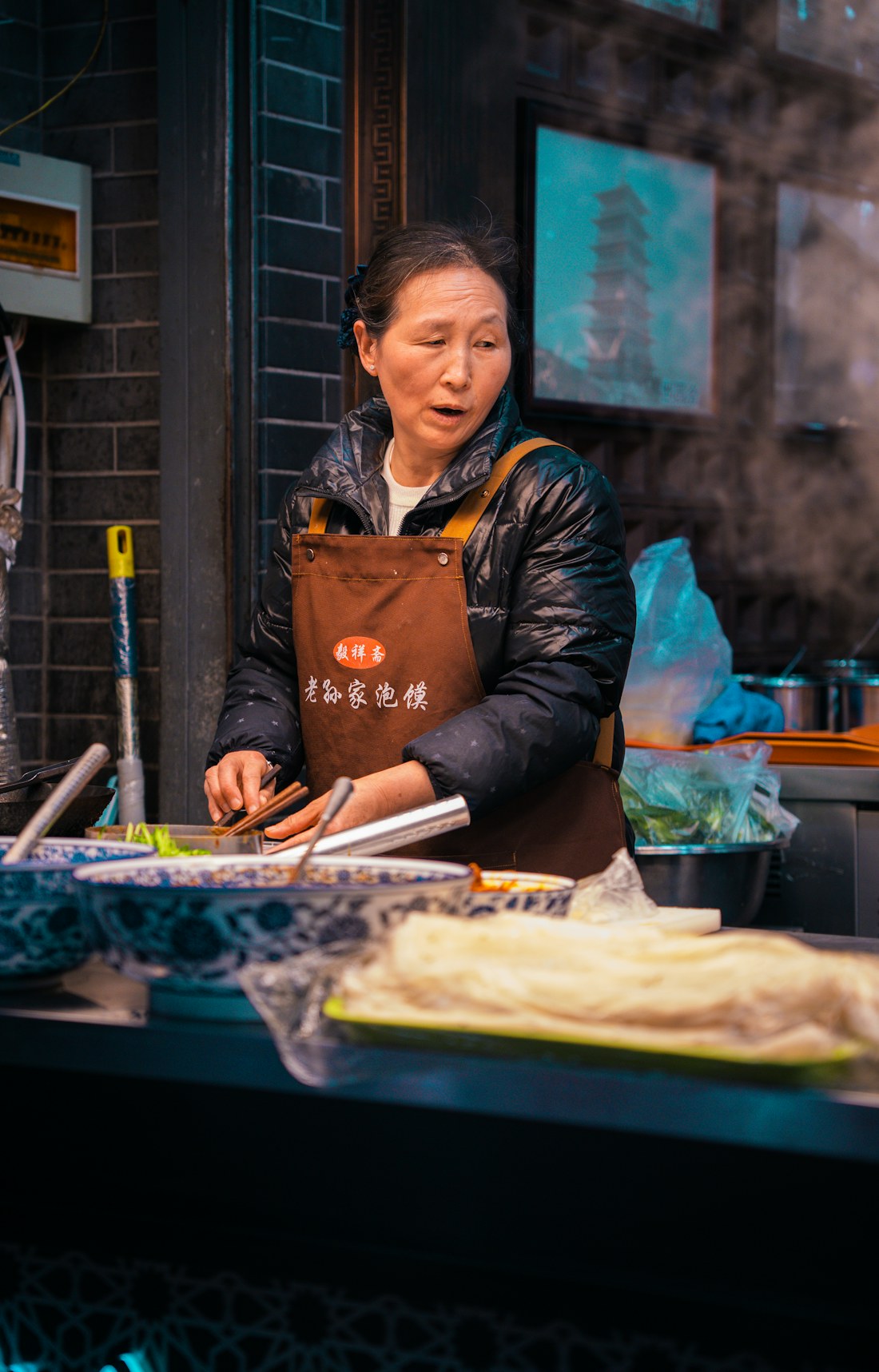 A vendor preparing food at a street stall in Xi’an