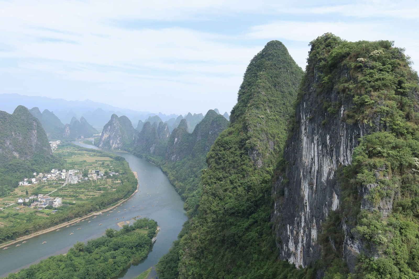 The Li River winding through green limestone mountains in Guilin, China