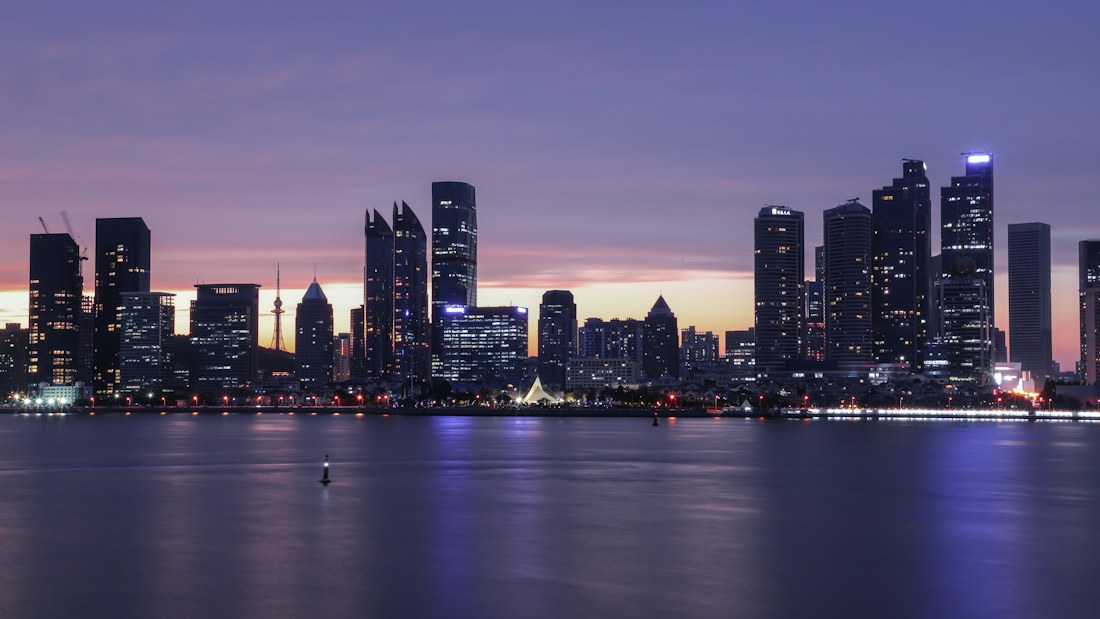 Qingdao waterfront skyline at dusk